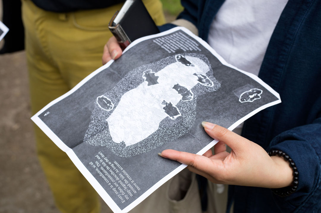 hands holding a photocopied map of Trout Lake.